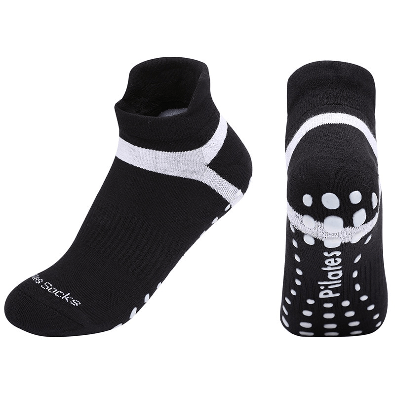 Black anti-slip compression women's socks for training with white accents, ideal for yoga and sports activities, featuring ergonomic design.