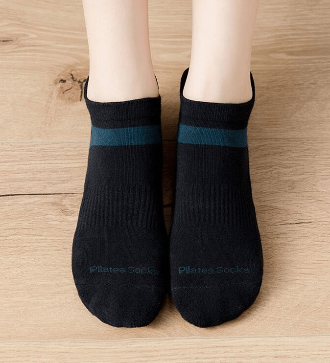 Black cotton anti-slip compression women's socks for training on wooden floor.