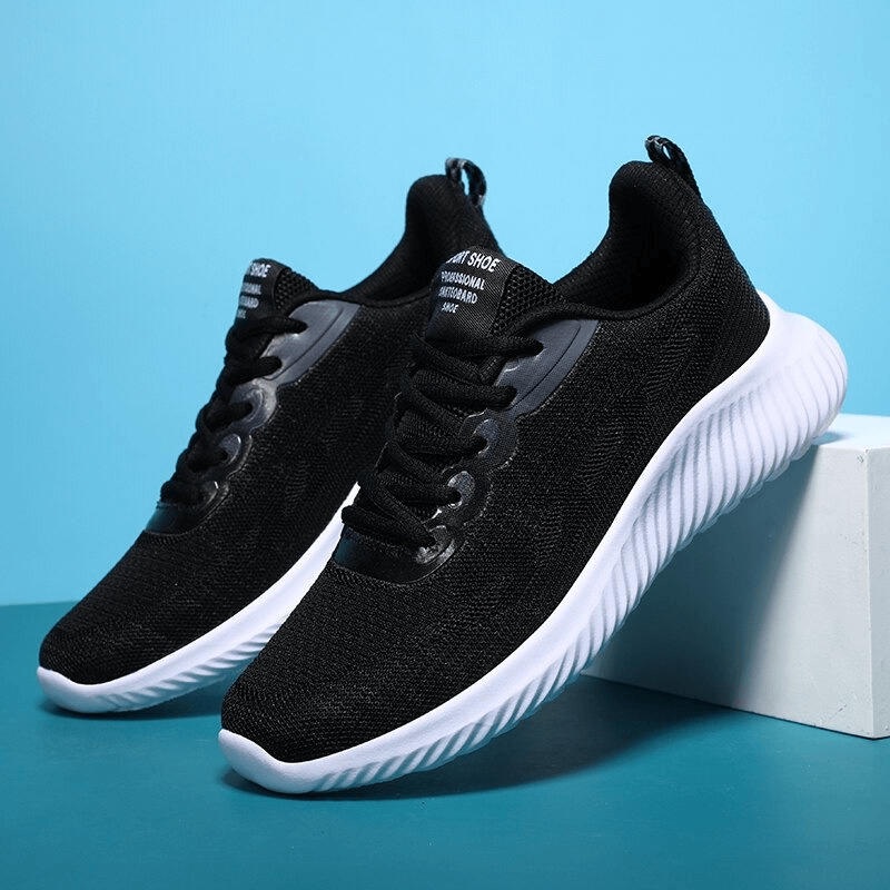 Women's breathable black running shoes with white sole, featuring quick-drying mesh for optimal comfort and flexibility.