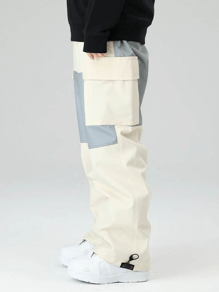 Unisex drawstring loose ski trousers with large pockets in beige and gray, perfect for snowboarding and extreme weather protection.