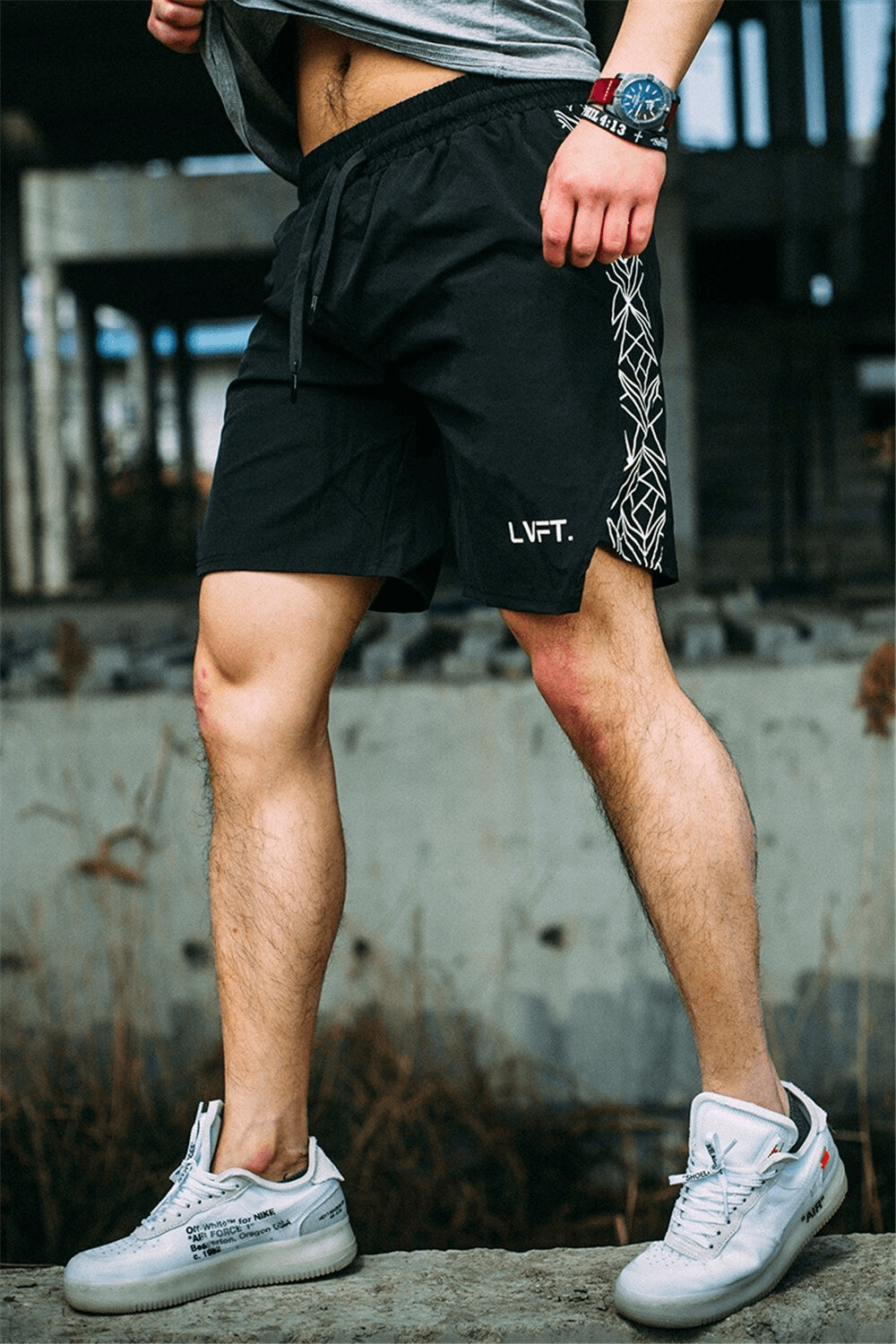 Man wearing black drawstring running shorts for gym workout, showcasing comfortable and stylish fitness clothing.