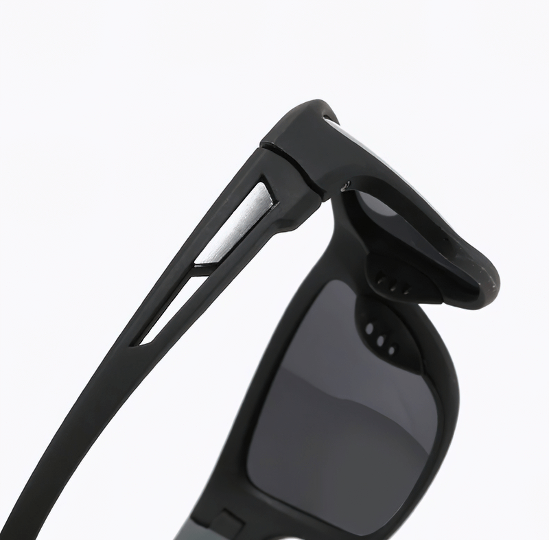 Close-up of black polarized sunglasses with durable frames, ideal for sports and hiking. Featuring UV400 protection and sleek design.