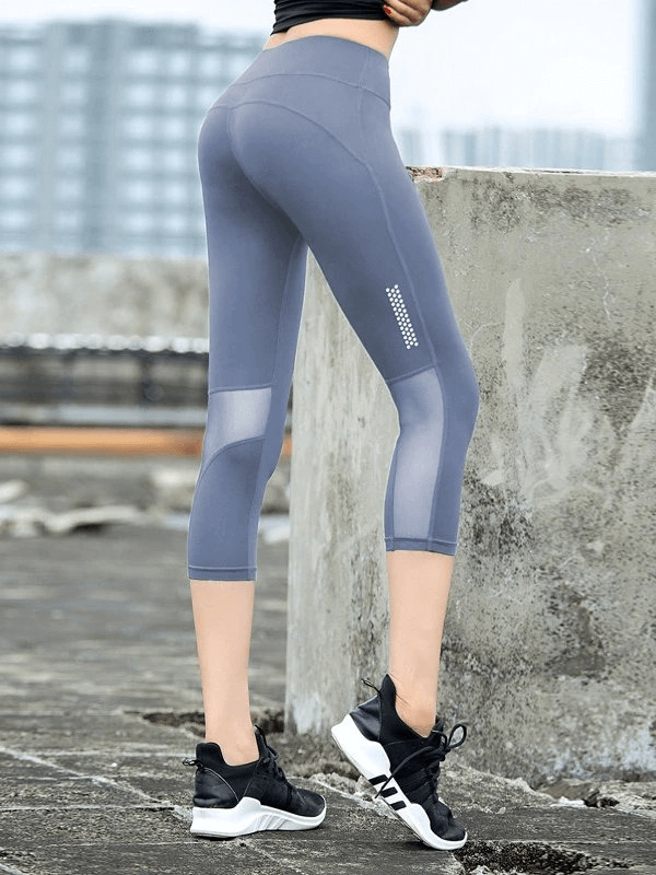Back view of stretchy breathable high-waisted cropped leggings perfect for yoga, in stylish grey, showing off comfort and flexibility.
