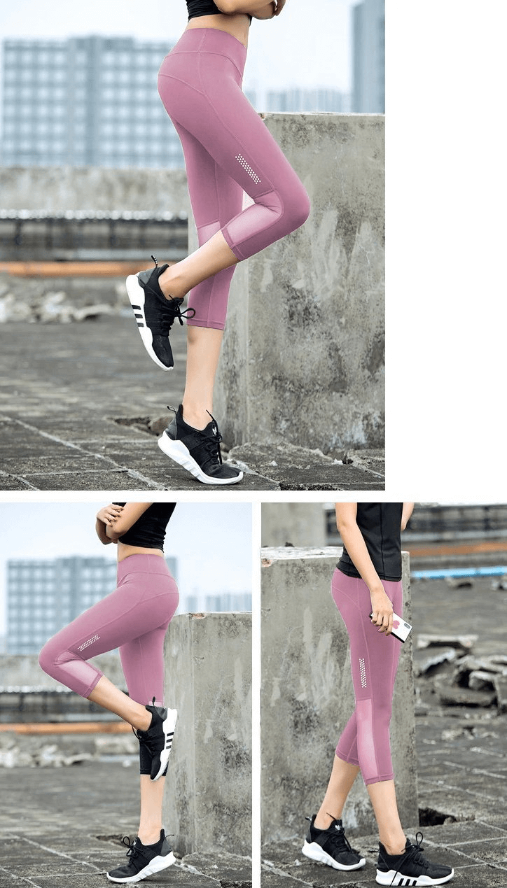 Woman wearing pink high-waisted cropped leggings designed for yoga, highlighting stretch and breathability, on urban rooftop.