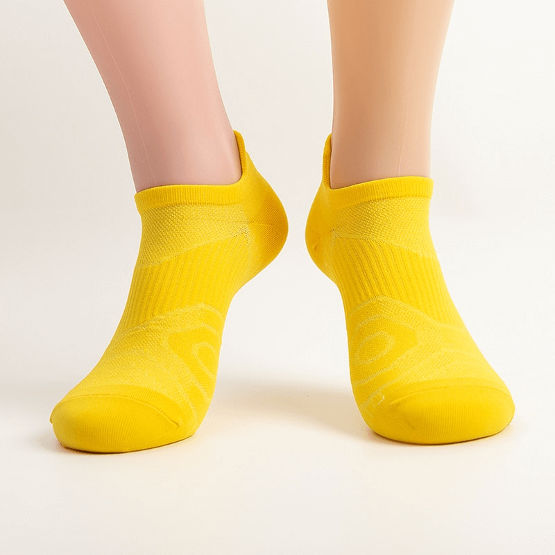 Bright yellow elastic breathable unisex short socks providing ankle-high comfort and snug fit for all genders and sizes.