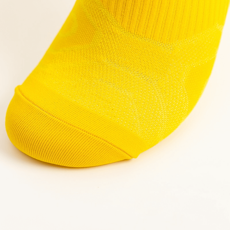 Bright yellow elastic breathable unisex short sock close-up, showing ankle-height and comfort-focused design.