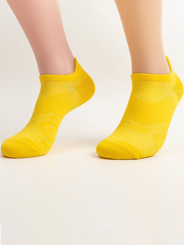 Bright yellow unisex ankle socks showcasing elastic and breathable fabric for comfort and style.