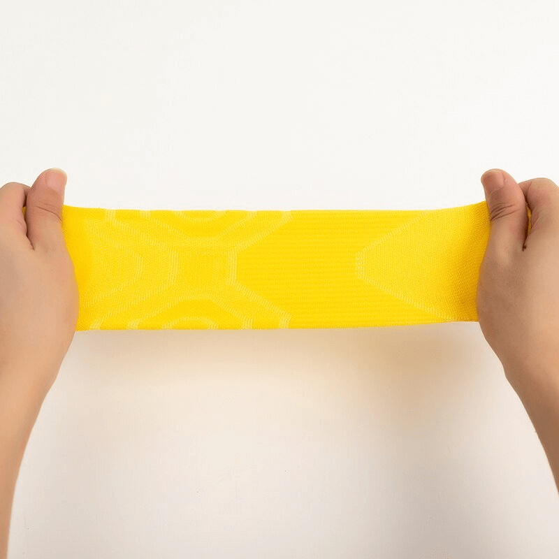 Elastic Breathable Unisex Short Sock in yellow being stretched to showcase durability.