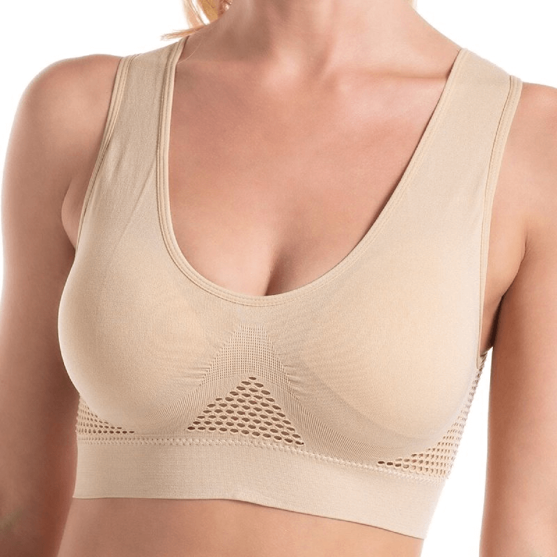 Elastic breathable women's sports bra with holes, featuring seamless wire-free design in beige color for all-day comfort and support.