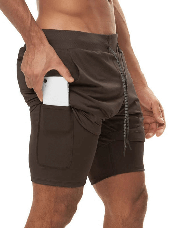 Man wearing elastic fitness running double shorts with a phone pocket, ideal for intense training and bodybuilding - SF0938
