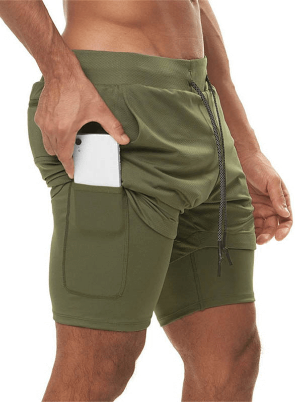 Man wearing olive green double-deck fitness running shorts with phone pocket, perfect for jogging and intense workouts.