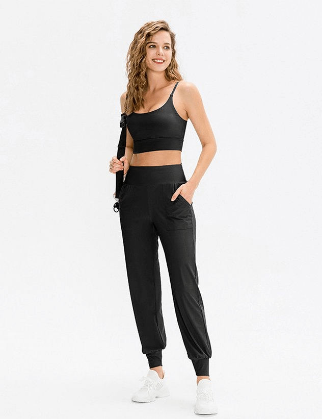 Elastic lightweight women's sweatpants with pockets for outdoor activities, shown with elastic waistband and full-length design.