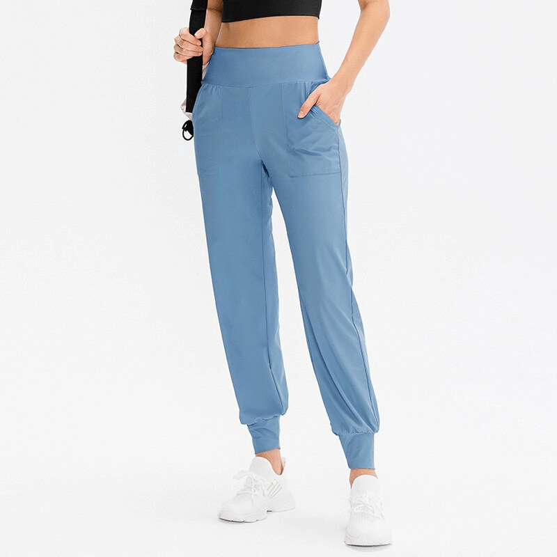 Elastic Lightweight Women's Sweatpants with Pockets in blue, perfect for outdoor activities. Features elastic waistband and side pockets.