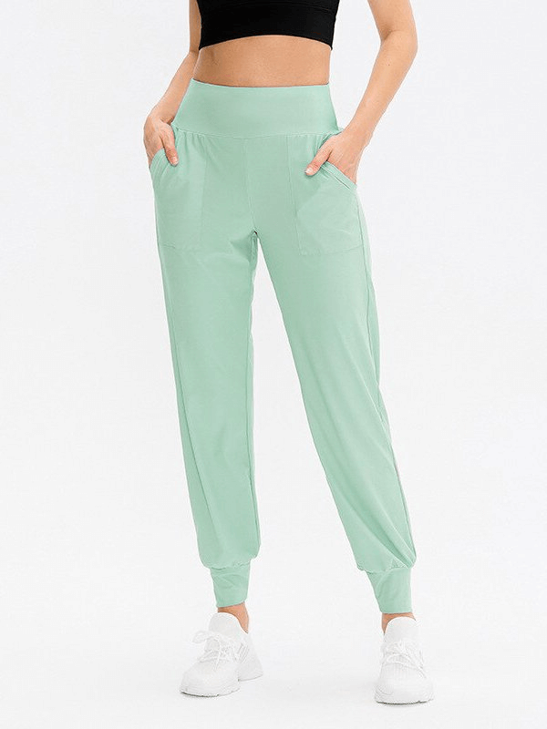 Mint green elastic lightweight women's sweatpants with pockets, ideal for yoga and workouts, featuring an adjustable waistband.