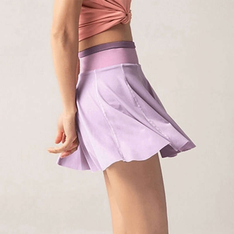 Woman wearing lavender elastic pleated skirt-shorts, side view. Perfect for yoga and running. Sportswear SF0208.