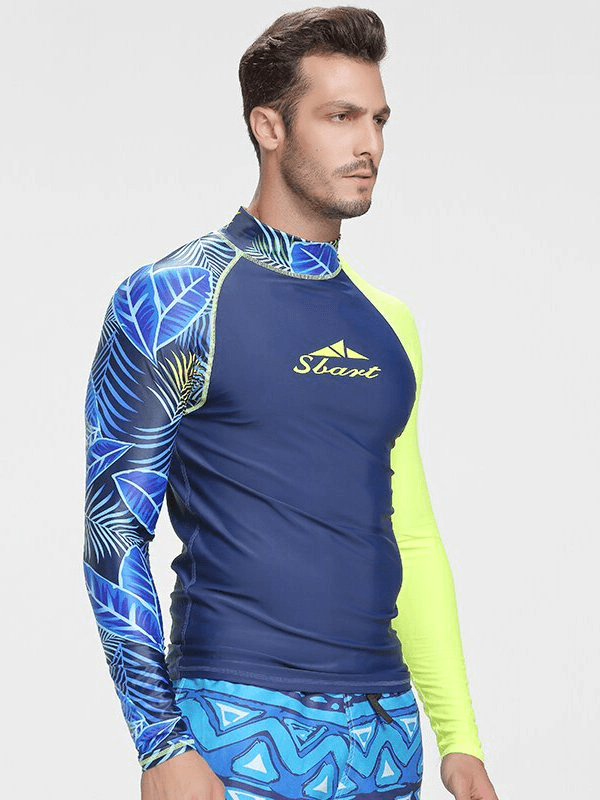 Man wearing Elastic Quick Dry Men's Long Sleeve Diving Top in blue with leaf pattern, ideal for surfing and swimming.