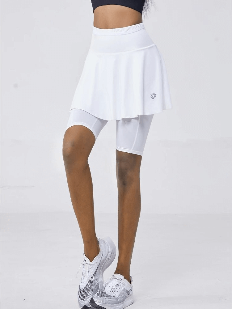 Woman wearing white high waist elastic skirt-shorts perfect for golf and tennis, showcasing quick-dry and breathable materials.