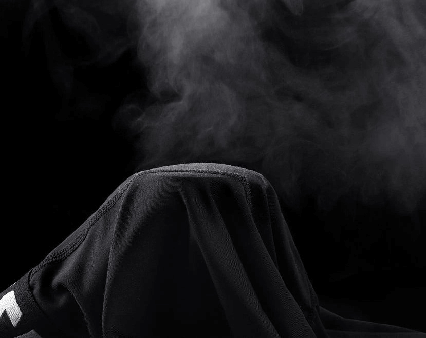 Elastic running pants with monochrome design releasing moisture vapor, showcasing breathable and comfortable sportswear for men.