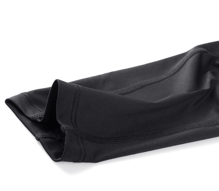 Close-up of black elastic running training men's pants, showcasing sleek and comfortable sportswear design with monochrome pattern.