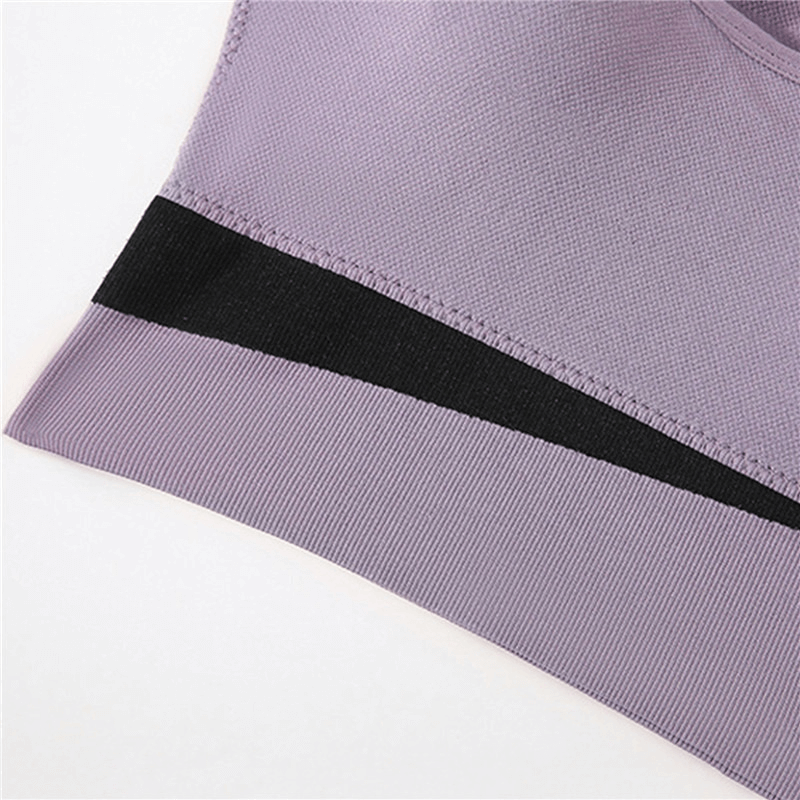 Close-up of purple elastic wireless women's sports bra fabric, highlighting breathable nylon texture and stylish black stripe design.
