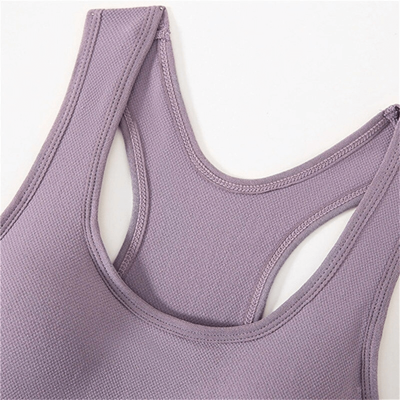 Lilac wireless sports bra with breathable nylon fabric, perfect for yoga and athletic activities. Provides comfort and freedom of movement.
