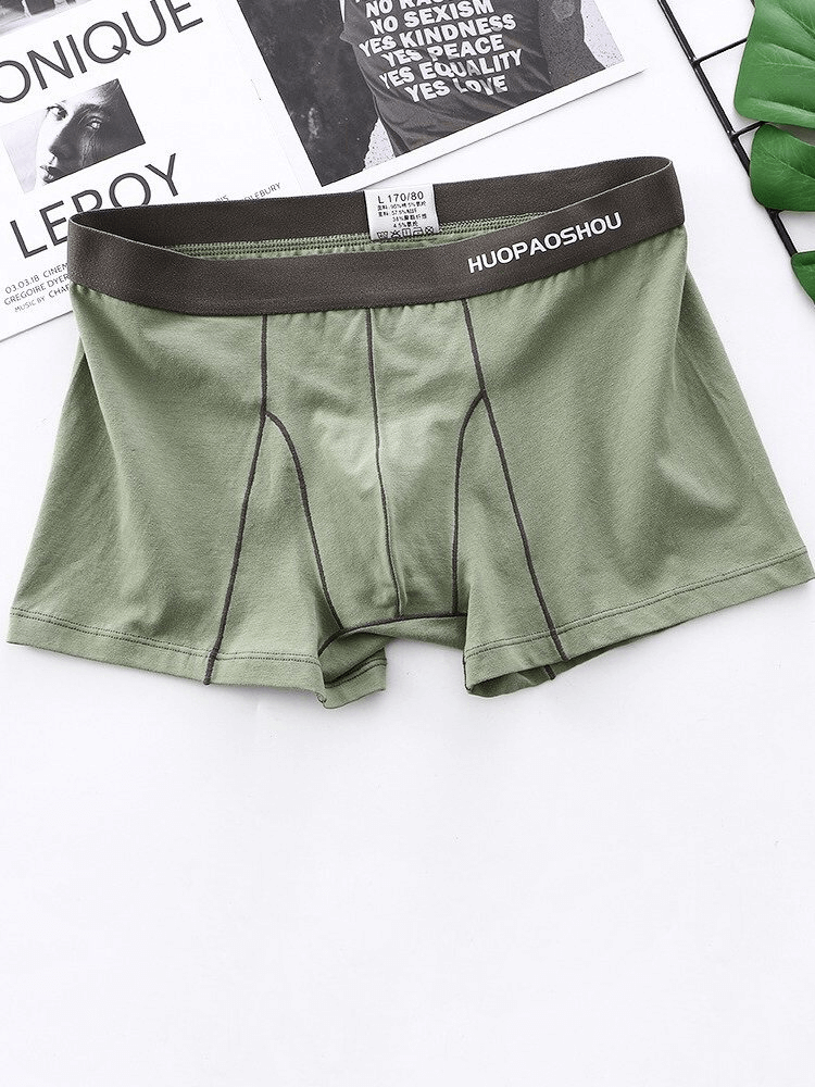 Men's green elastic soft boxer briefs with solid pattern and comfy waistband, made from premium cotton for superior comfort.