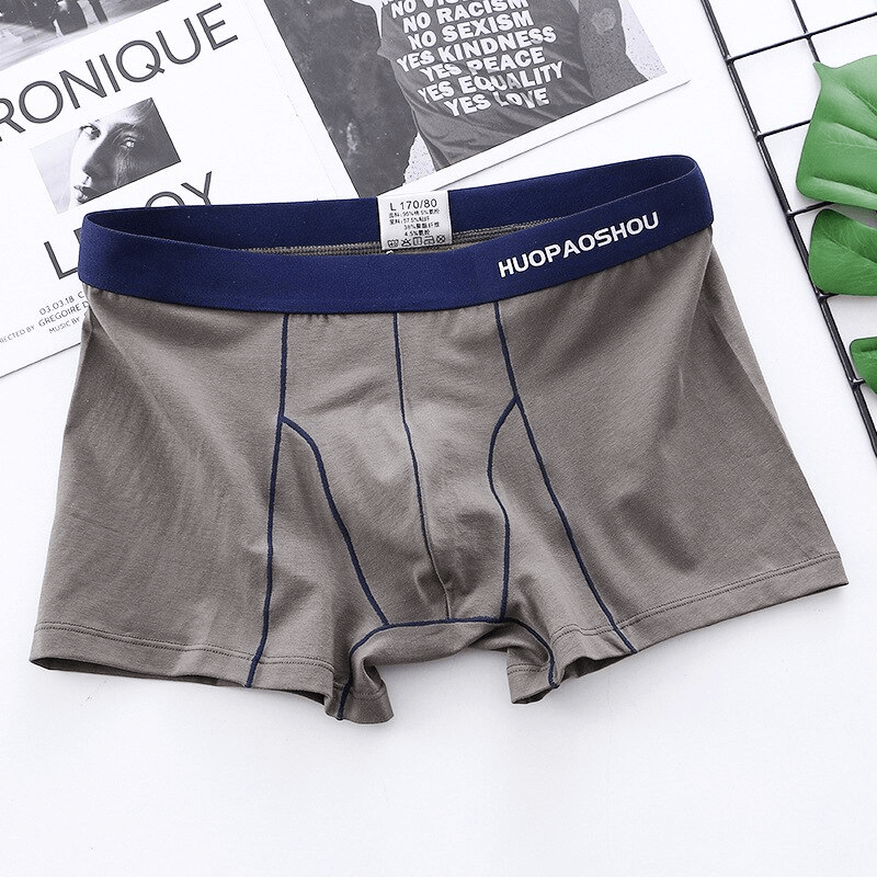 Men's elastic soft boxer briefs in solid pattern with blue waistband, crafted from premium cotton for comfort and durability.