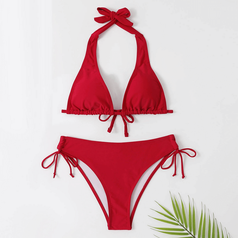 Red solid color women's split swimwear set with halter neck design and side-tie bikini bottoms, perfect for beach wear and sunbathing.