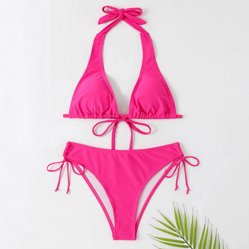 Vibrant pink bikini top and bottom set for women, featuring a tie halter neck and split design, perfect for beachwear and sunbathing.