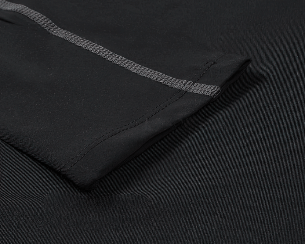 Close-up of black elastic sports quick-dry women's shirt sleeve showing stitching and fabric texture for fitness activities.