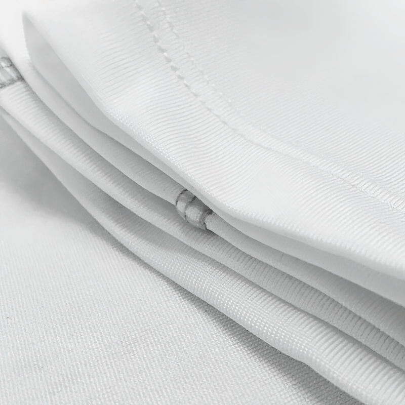Close-up of white elastic sports quick-dry women's shirt fabric, showcasing stitching and breathable, lightweight material.
