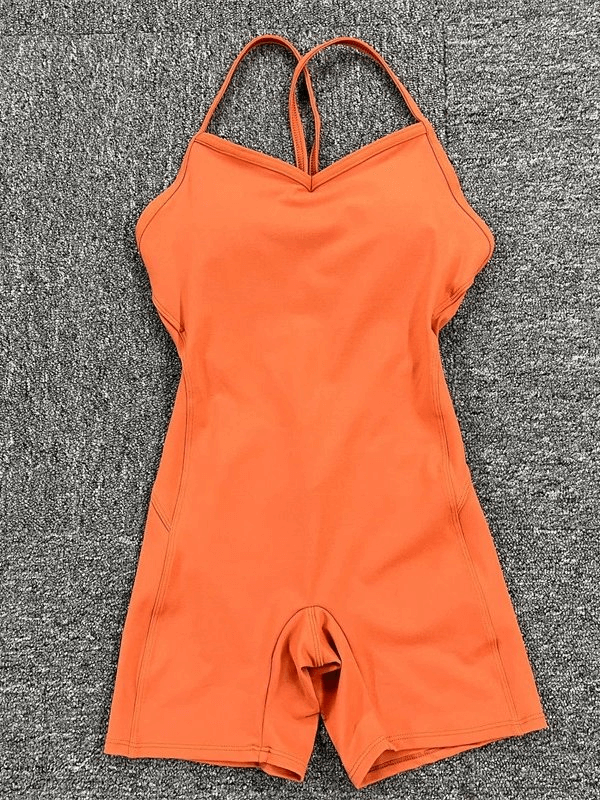 Orange elastic sports short jumpsuit with stylish open-back design, perfect for active women's workouts. Model SF0243.