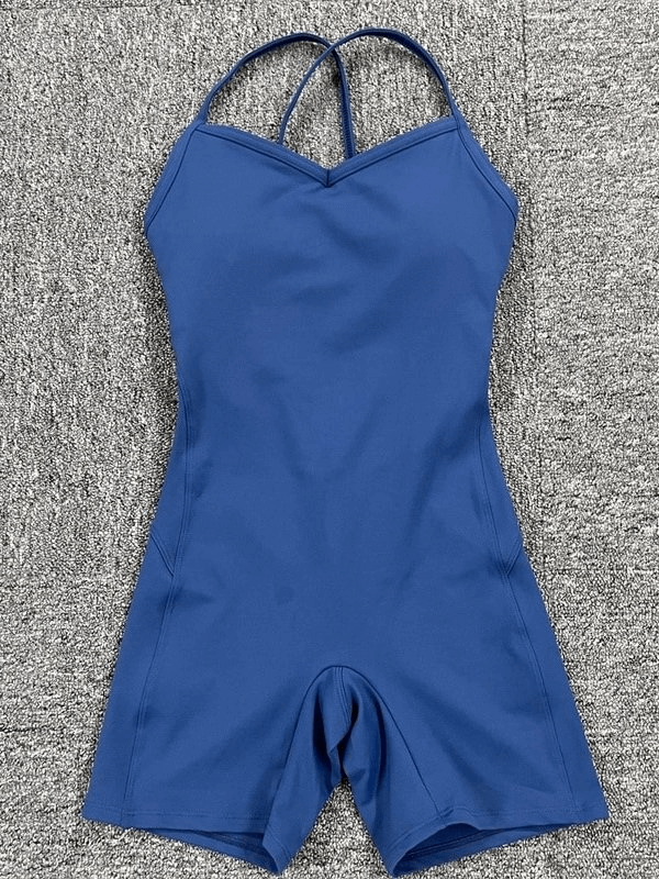 Elastic sports short women's open-back blue jumpsuit on gray background, featuring breathable and stretchy material.