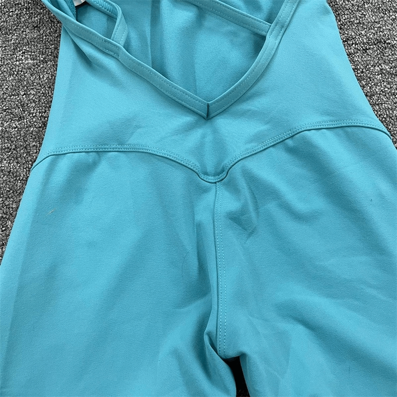 Turquoise women's open-back sports jumpsuit with high elasticity fabric for flexible workouts.
