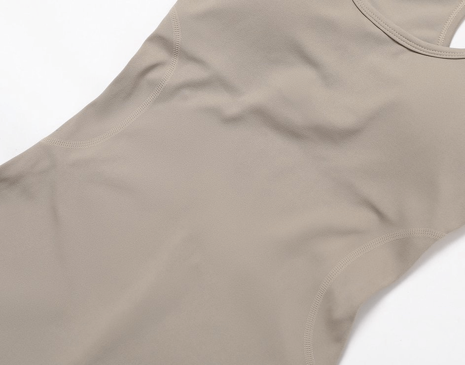 Elastic Sports Women's Jumpsuit for Training with Open Back in beige color, made of breathable nylon and spandex for flexibility and comfort.
