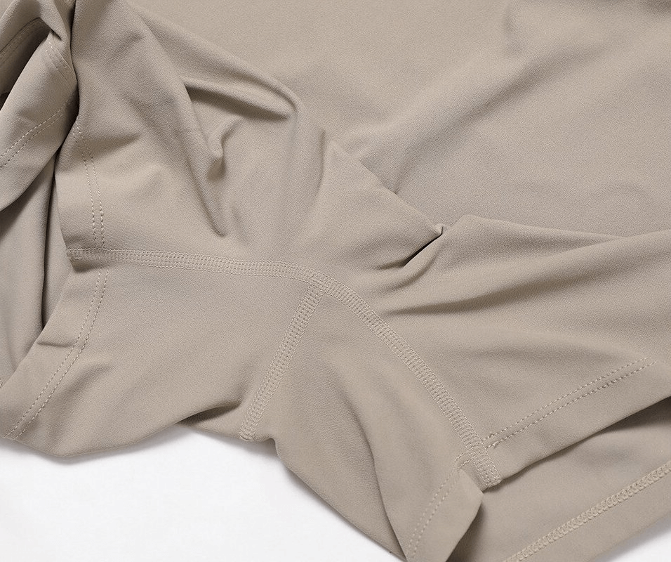 Close-up of beige elastic sports fabric with precise stitching, highlighting breathable and flexible material for women's jumpsuits.
