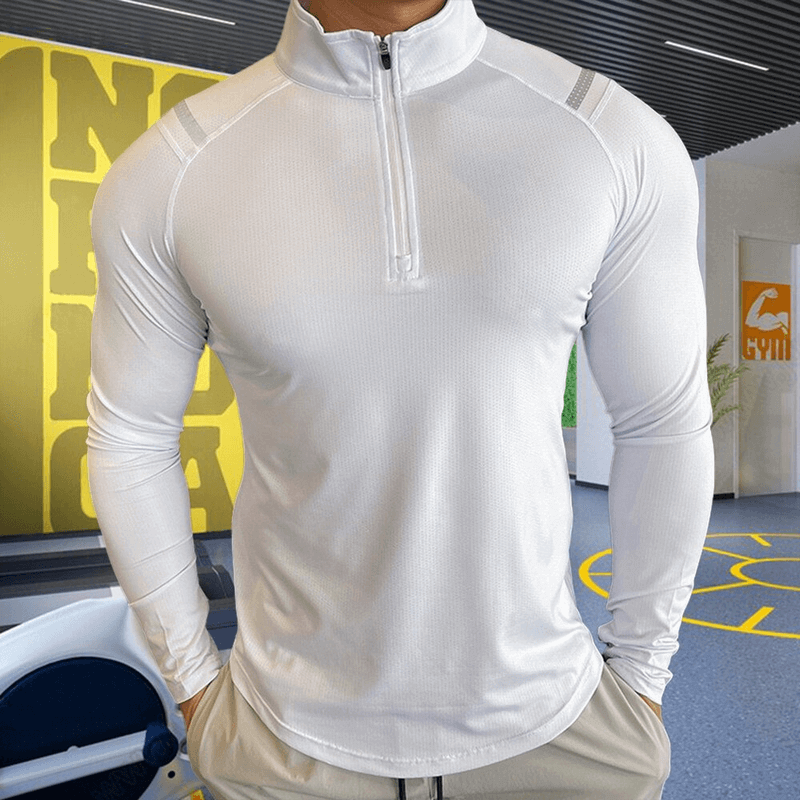 Men's elastic sports top with long sleeves and zipper, made from microfiber, in a gym setting. Stylish and breathable design.