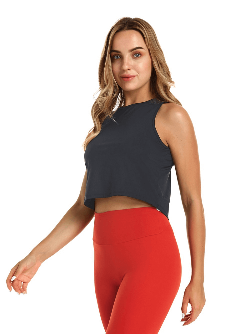 Elastic stylish women's top with back cutout, perfect for yoga, shown on model wearing bright red leggings.