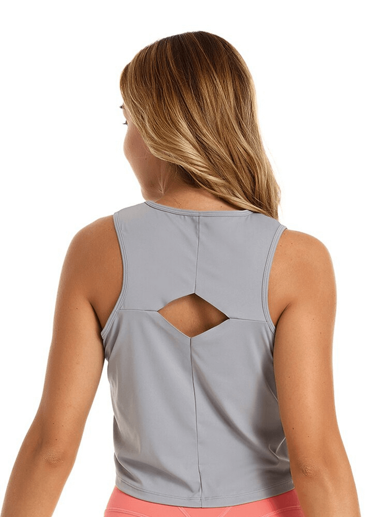 Model wearing elastic stylish women's top with back cutout, ideal for yoga, showing breathable fabric and comfortable fit.