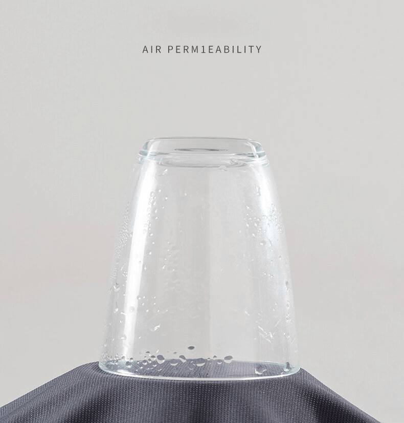 Demonstrating polyester fabric's breathability with condensation under a glass, showcasing air permeability.