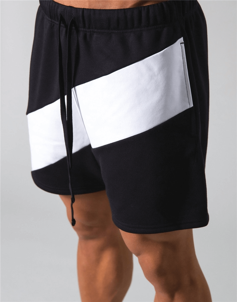 Elastic waist patchwork running shorts with black and white design for gym wear, made from cotton blend, featuring secure fit for sports.