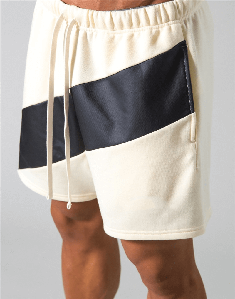 Men's elastic waist patchwork running shorts with black and white design, perfect for gym workouts. Comfortable cotton blend.