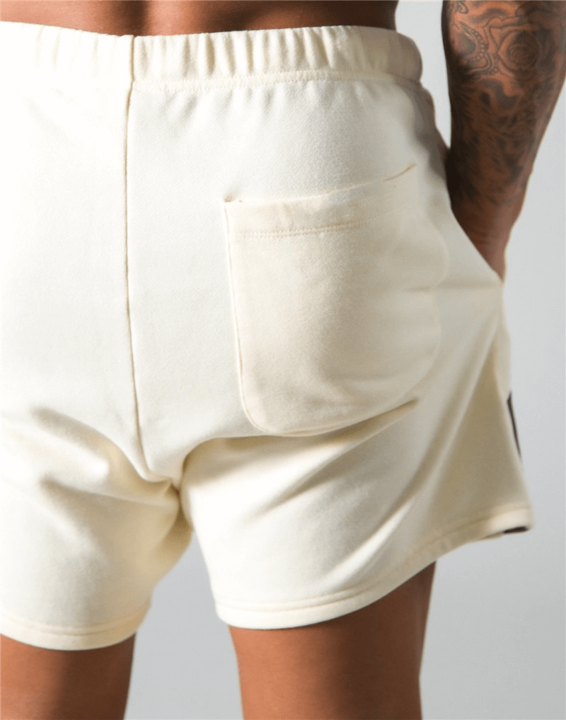 Elastic Waist Patchwork Running Shorts in cream, featuring a pocket, ideal for gym workouts; shown from the back highlighting the fit.