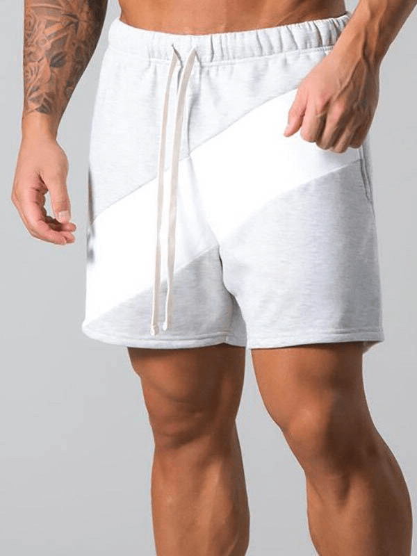 Man wearing elastic waist patchwork running shorts in grey with a white stripe, ideal for sports and gym workouts.