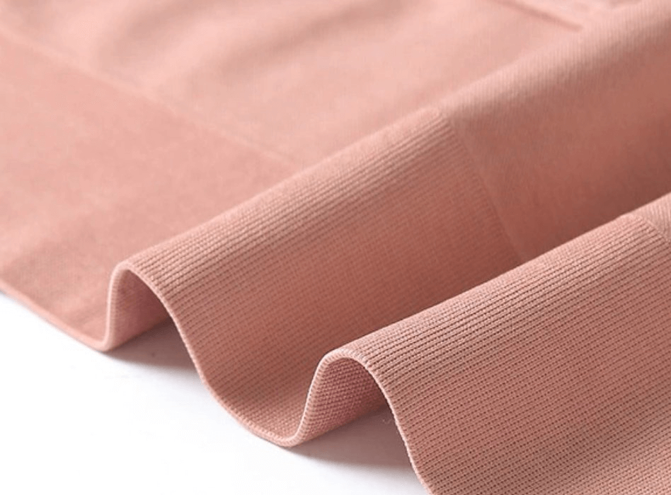 Close-up of soft pink fabric showcasing the ribbed texture of the Elastic Women's Sports Top Bras With Straps With Zipper - SF0443.