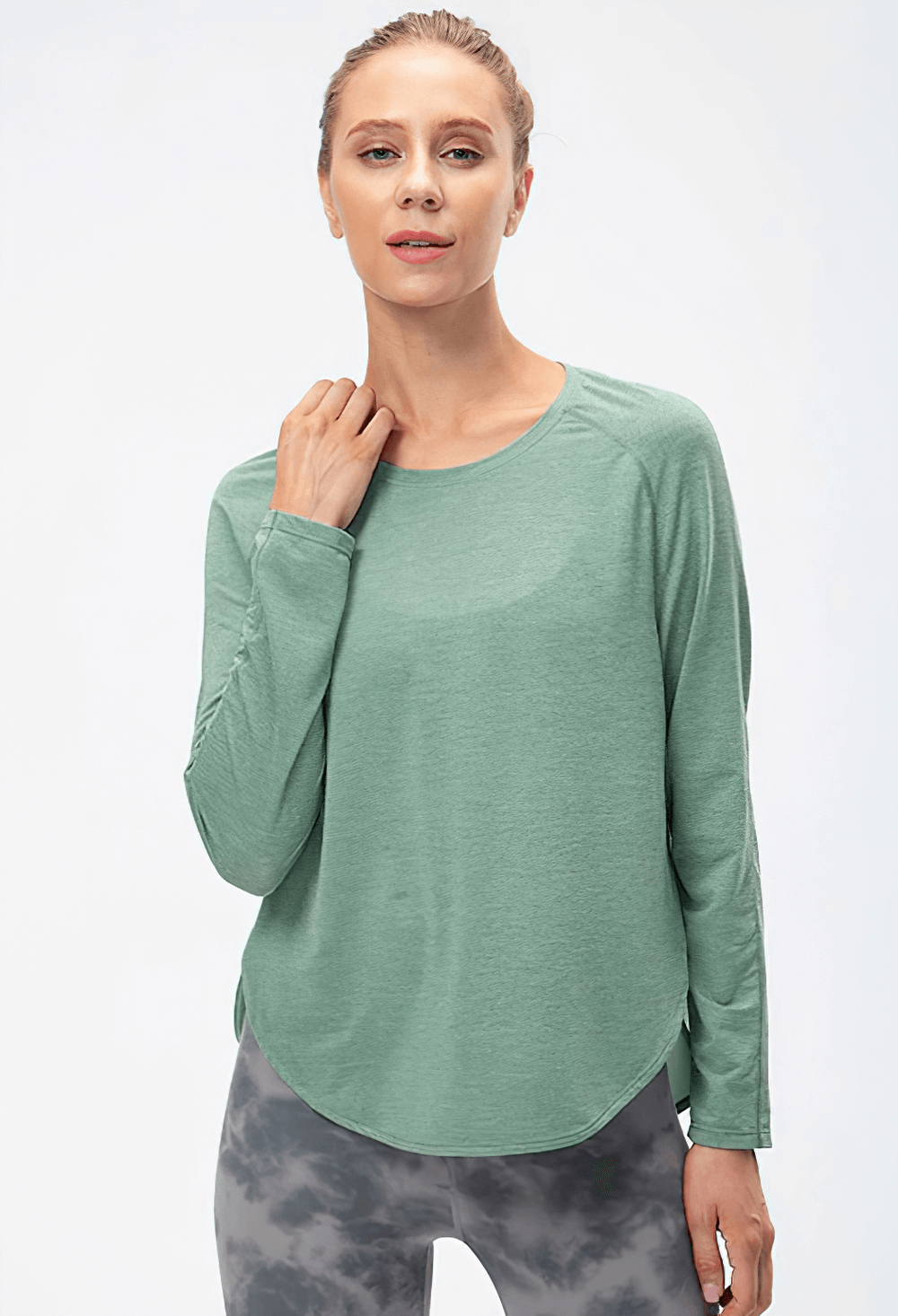 Green long sleeve loose sports top with draped hem and full split design, perfect for women's yoga and workouts.