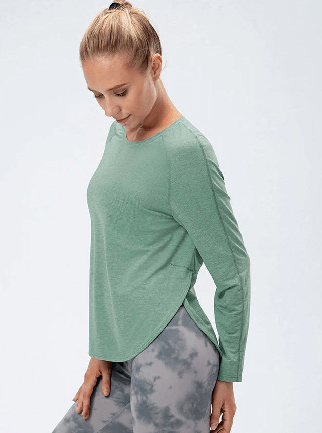 Woman wearing green Elasticity Loose Top with long sleeves and draped hem, ideal for yoga; stylish and breathable sports attire.