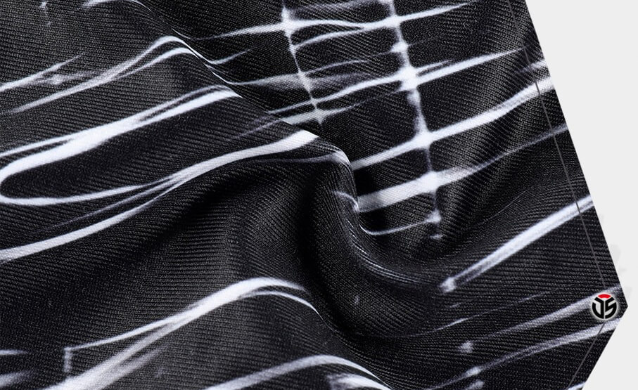 Close-up of breathable quick-dry fabric in black and white pattern, part of the Fashion Bicycle Beanie Cap for outdoor activities.