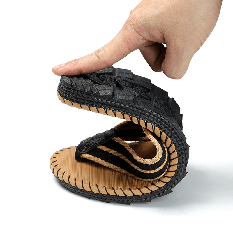 Flexible breathable beach flip flop for men being bent to show lightweight EVA design and durable rubber outsole.