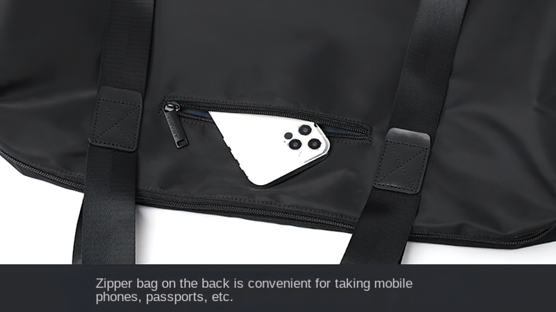 Close-up of black nylon shoulder bag with a back zipper pocket holding a smartphone, ideal for travel and sports essentials.